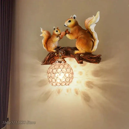 Nordic vintage style resin wall lamp featuring two detailed warm-toned squirrels on a branch above a crystal globe shade
