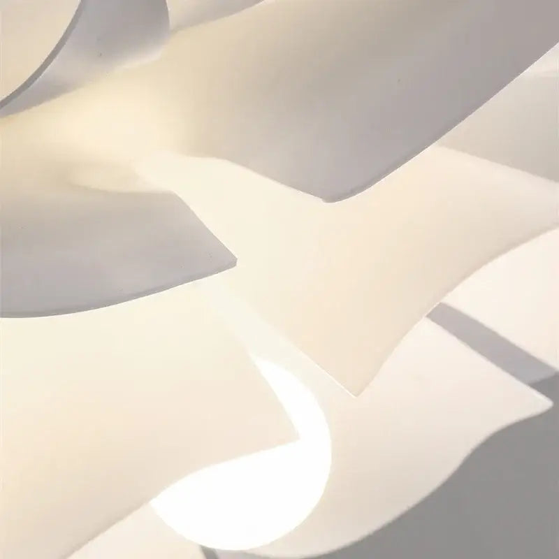 Nordic white acrylic flower pendant chandelier with layered flowing petals creating a soft glow for bedroom decor