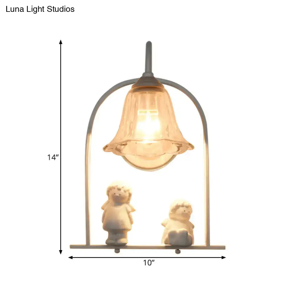 Nordic white arched frame flower glass pendant light with a delicate bell-shaped lamp and two white figurines inside