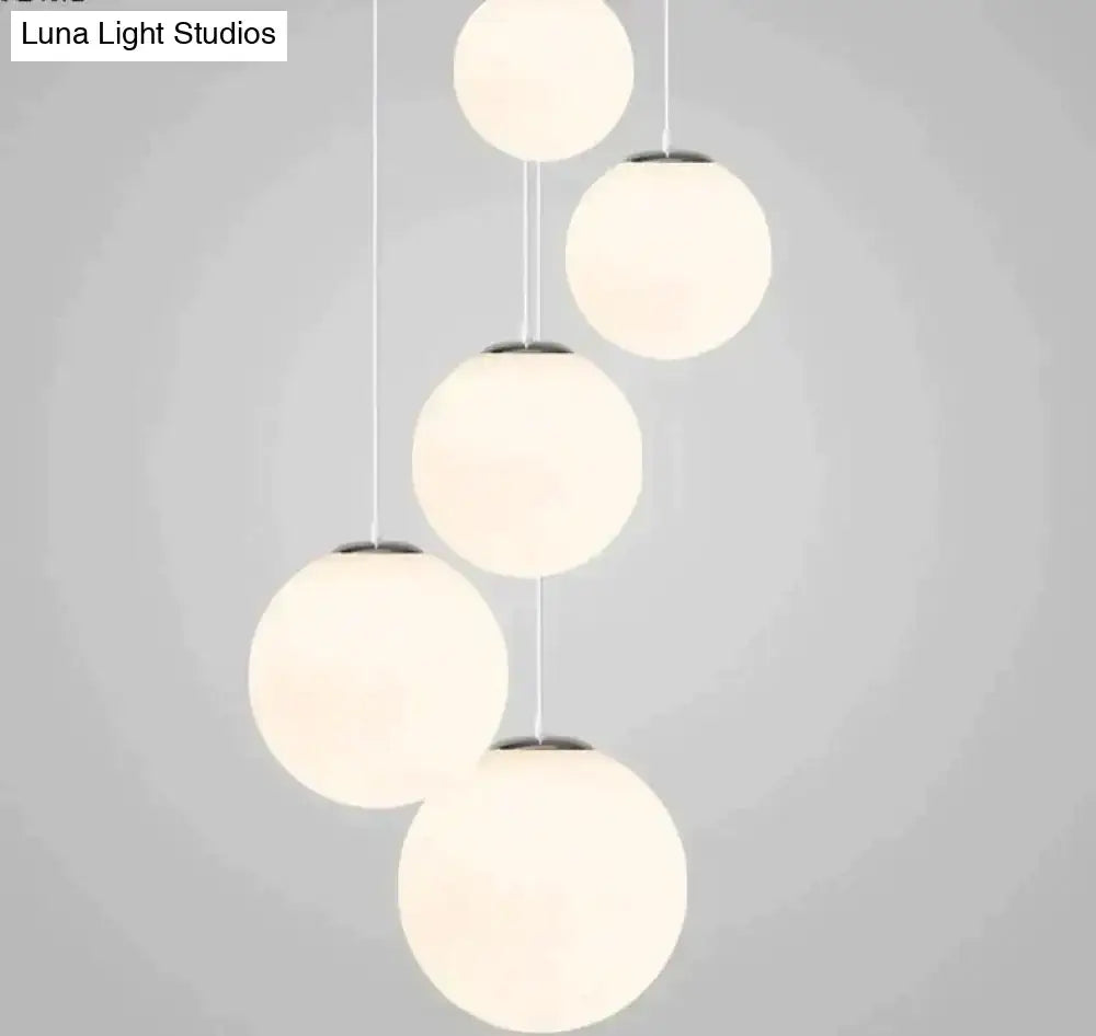 Modern nordic white glass ball pendant lights with frosted glass shades and sleek metal fixtures for living room use