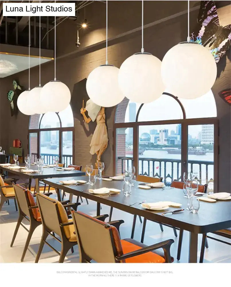 Modern white spherical pendant lights made of nordic white glass ball hanging from ceiling for living room use
