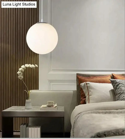 A sleek matte nordic white glass ball pendant light with minimalist design for modern living rooms and bars