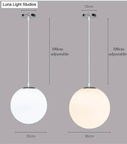 Two nordic white glass ball pendant lights with frosted shades and chrome fixtures for modern living rooms