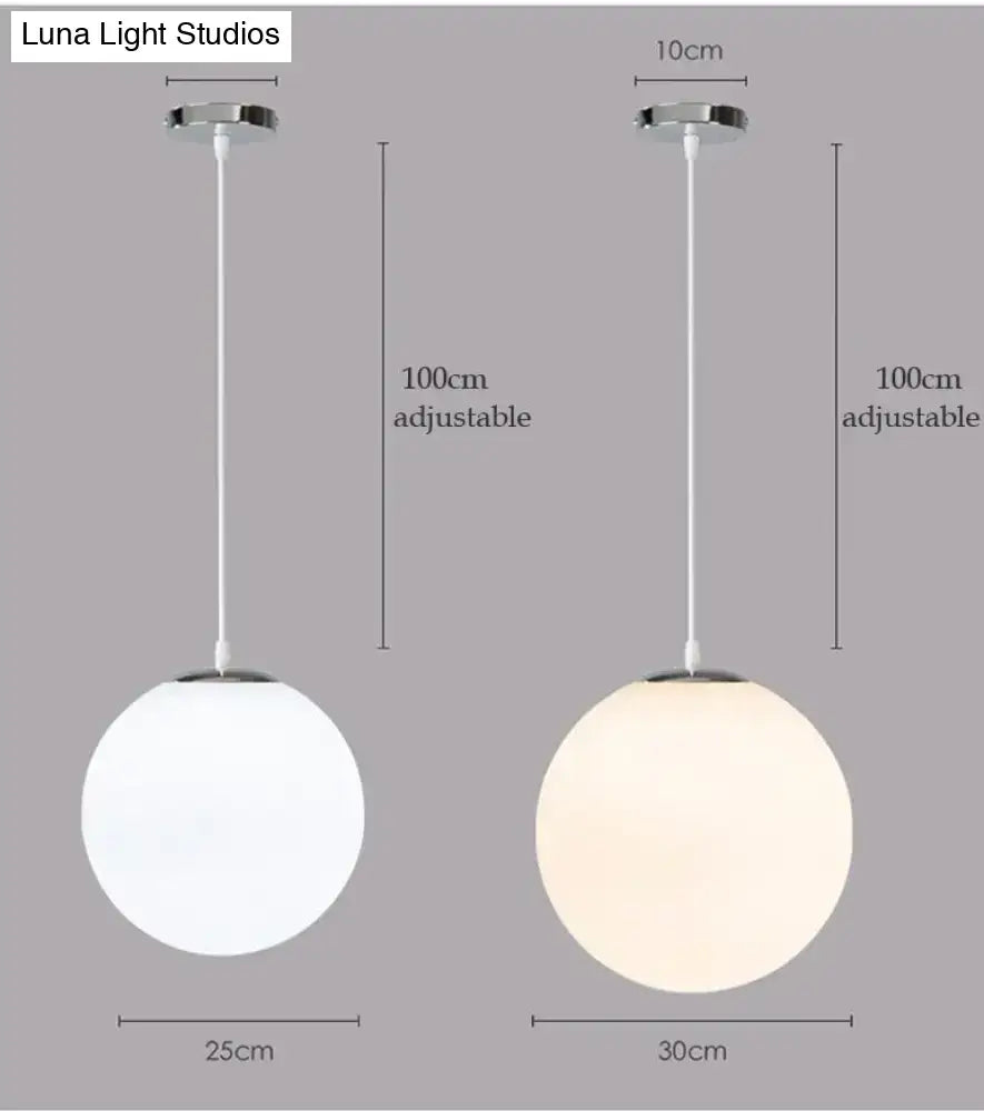 Two nordic white glass ball pendant lights with frosted shades and chrome fixtures for modern living rooms