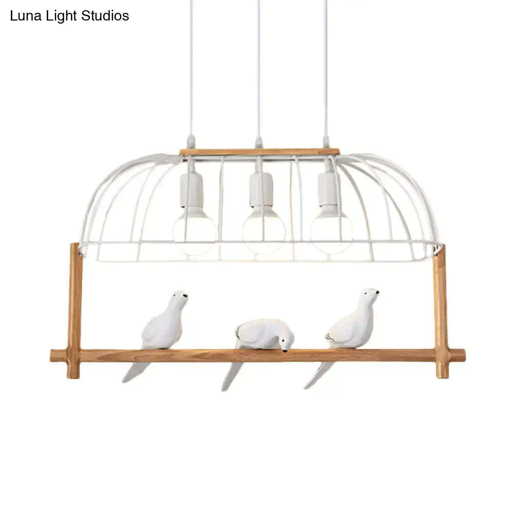 White ceramic bird figurines sit on a wooden shelf beneath a DecorBites™ nordic style white iron island pendant fixture