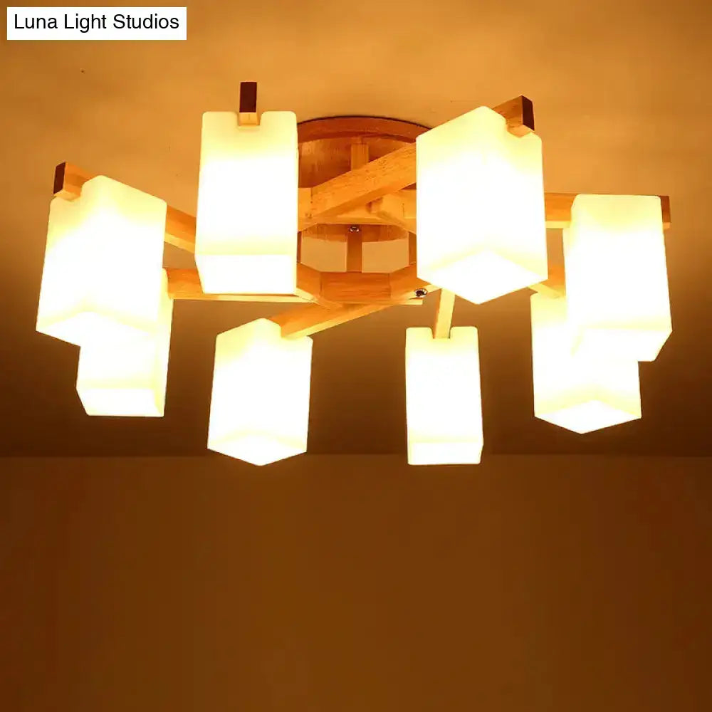 Nordic wood ceiling lamp with cuboid cream glass shades hangs elegantly in a living room setting