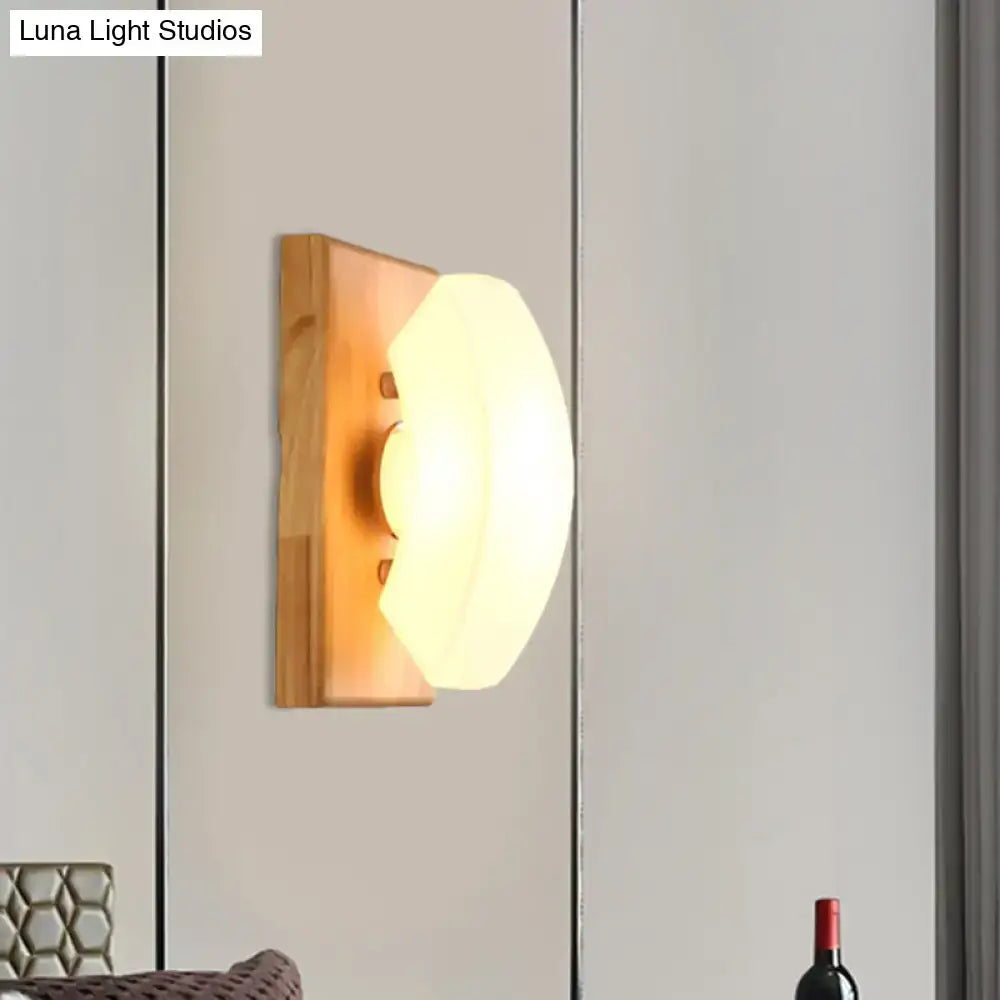Nordic wood and frosted white glass wall light with warm-toned oval frosted glass and natural wood base for bedroom sconce