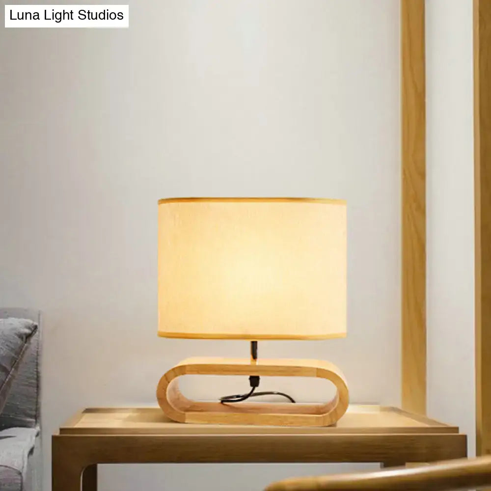 A warm-toned cylindrical lampshade on a curved wooden base nordic wood bedside table light 12 inch fixture