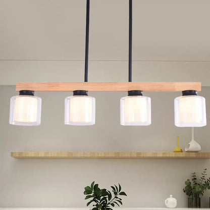Modern minimalist pendant light with natural wood bar black metal accents and double clear glass cylinder shades for island lighting