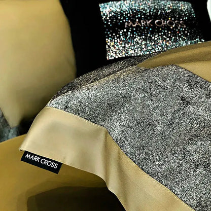 A bedding set featuring shimmering silver glitter fabric with beige satin trim and mark cross label from decorbites 1400tc egyptian cotton collection