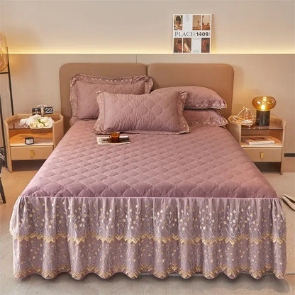 Lavender quilted bedspread with floral embroidery and ruffled hem paired with olive green and white floral bed skirt set with lace trim