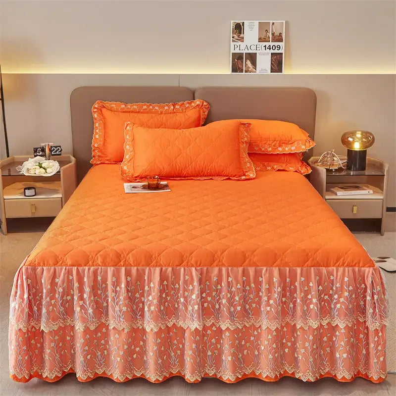 Orange quilted bed skirt with floral lace trim and ruffled hem in an olive green and white floral bed skirt set