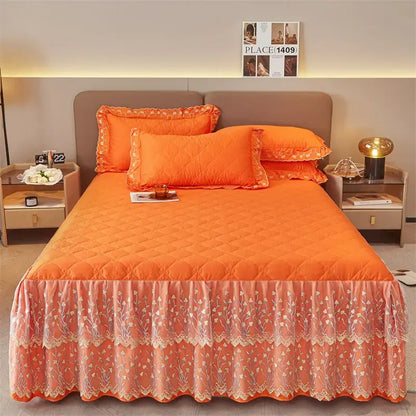 Orange quilted bed skirt with floral lace trim and ruffled hem in an olive green and white floral bed skirt set
