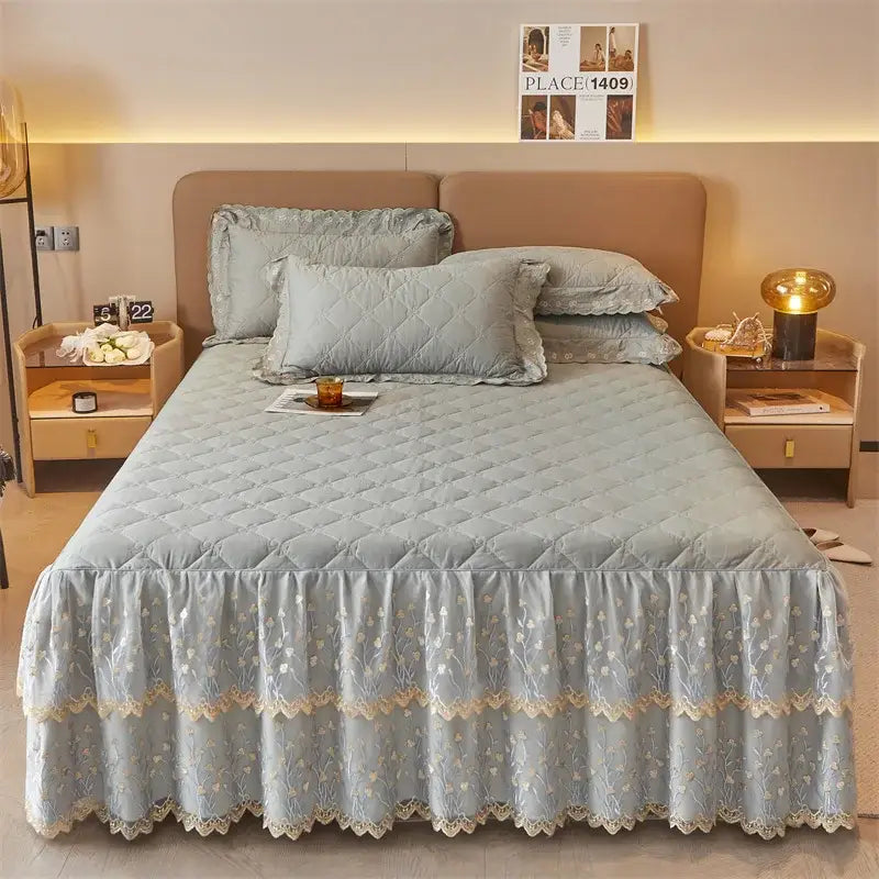 Light blue quilted bed skirt with delicate floral embroidery and lace trim in olive green and white bed skirt set