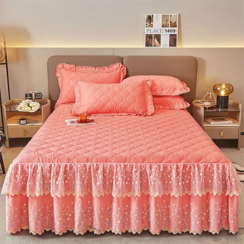Pink quilted bed skirt with delicate lace trim and floral embroidery in a bed skirt set for elegant bedroom decor
