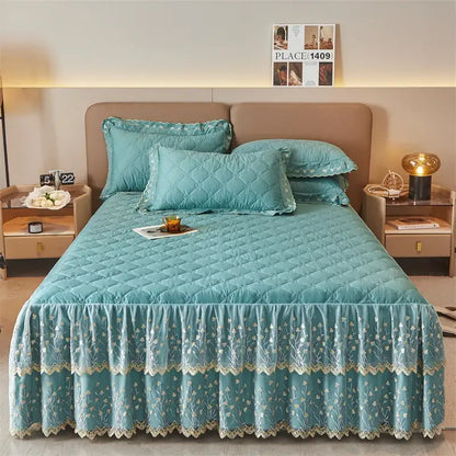 Teal quilted bed skirt set with floral embroidery and lace trim complementing olive green and white bedroom decor