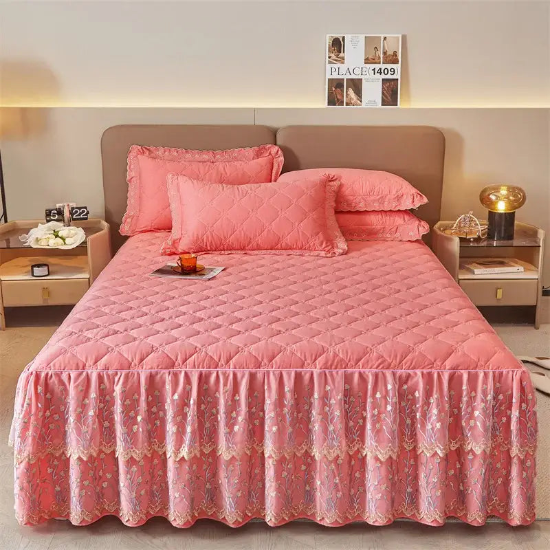 Pink quilted bed skirt with floral embroidery and lace trim in an olive green and white floral bed skirt set