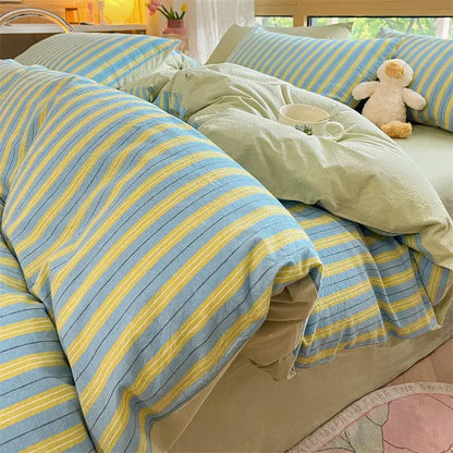 A cozy striped cotton bedding set in olive green and cream with a soft light blue and yellow bedspread decorbites cozy striped