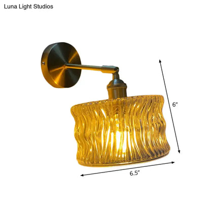 Golden wavy glass wall lamp with brass metal arm and mounting plate for elegant bedroom wall lighting