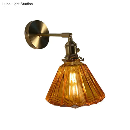 Vintage-style bedroom wall lamp with brass finish and amber fluted glass shade for elegant bedroom wall lighting