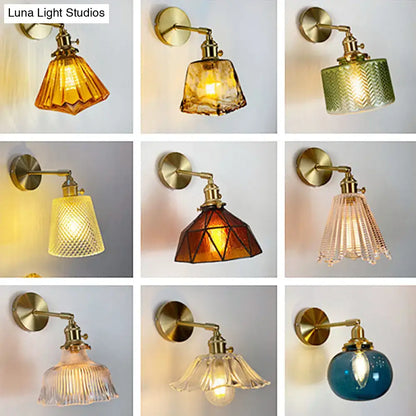 Vintage-style brass bedroom wall lamp with orange and gold fluted glass shades in various colors and patterns