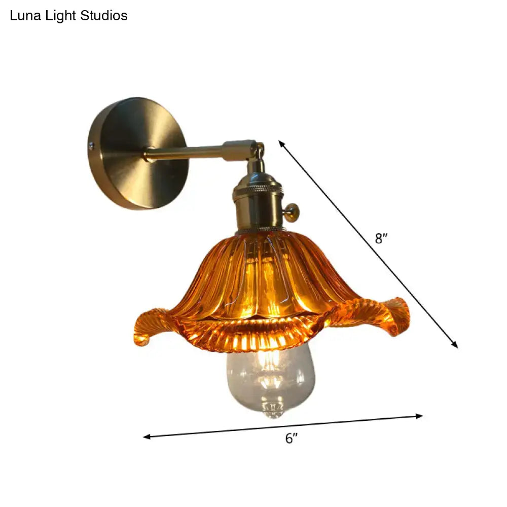 A vintage-style bedroom wall lamp with brass-finished metal and an amber fluted glass shade for bedroom wall use