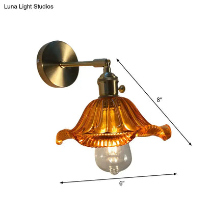 A vintage-style bedroom wall lamp with brass-finished metal and an amber fluted glass shade for bedroom wall use