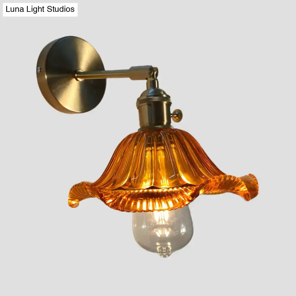 A warm amber fluted glass wall lamp with brass mount perfect as an orange and gold bedroom wall lamp