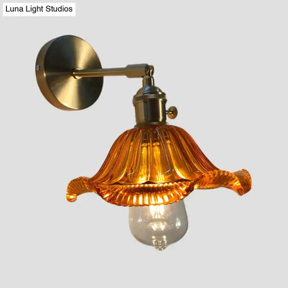 A warm amber fluted glass wall lamp with brass mount perfect as an orange and gold bedroom wall lamp