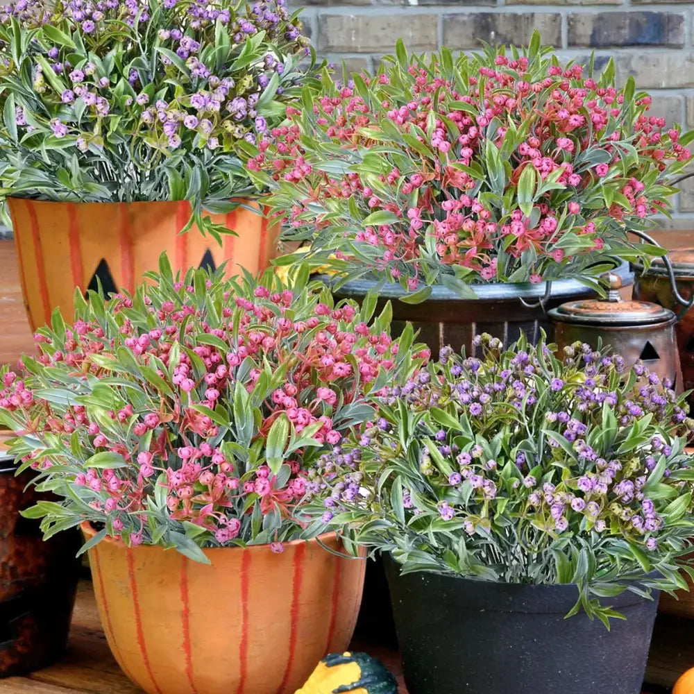 Orange pumpkin-shaped planter with vertical red stripes and black accents featuring babysbreath lover fruit artificial plant