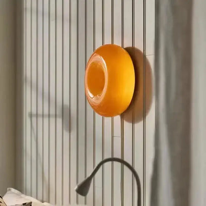 Vibrant orange translucent silicone soap dish with smooth rounded design complementing decorbites glass donut led wall sconce