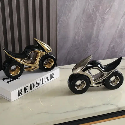 Two sleek ceramic motorcycle light decorations in black gold and black silver on marble for living room display