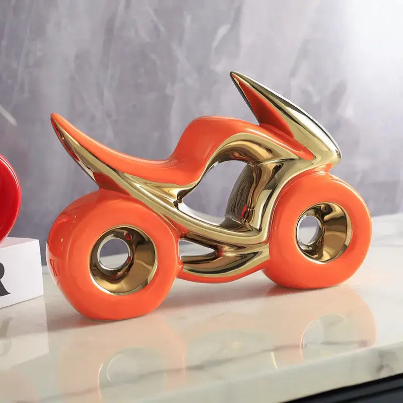 Vibrant orange and gold ceramic motorcycle light decoration with glossy reflective surfaces for living room display