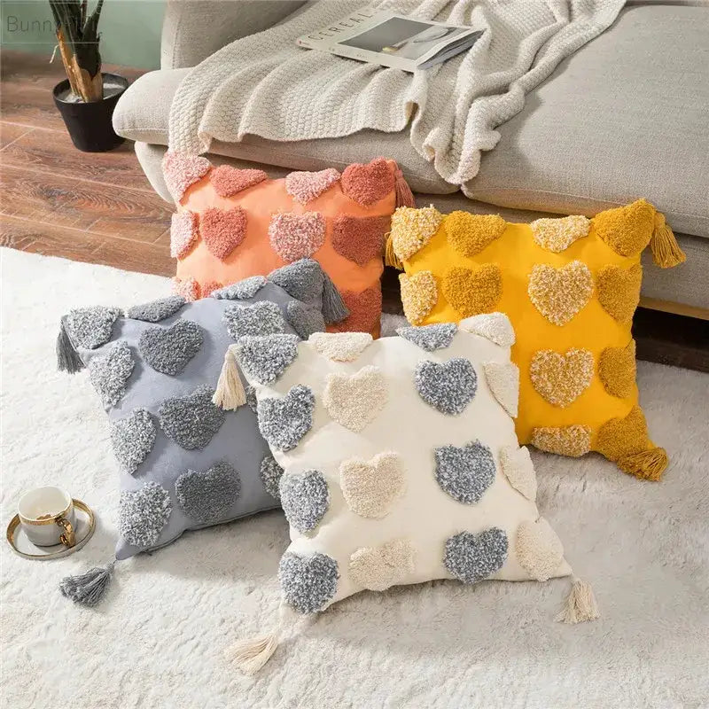 Four cozy orange and grey heart embroidery cushion covers with tassels and pom-pom hearts for living room decorbites