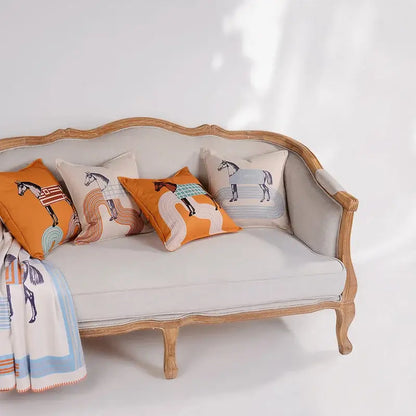 Beige upholstered sofa with ornate light wood frame and decorbites 45x45 square orange horse 45x45 square throw pillowcase living room decor