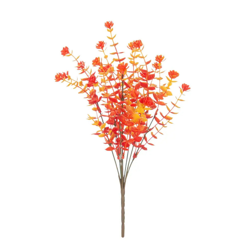 A vibrant artificial autumn bouquet with orange and red artificial eucalyptus leaves in a white pitcher garden decor