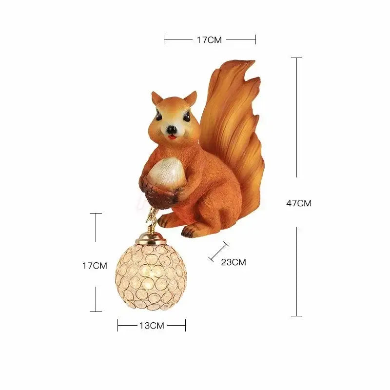 Orange squirrel crystal led wall lamp with textured tail holding acorn above crystal-encrusted spherical base decorbites wall lamp