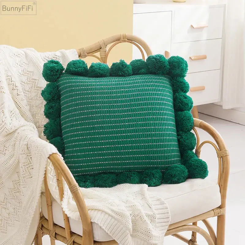 Emerald green knitted ball cushion cover with fluffy pom-pom trim and subtle white dotted pattern for living room decor