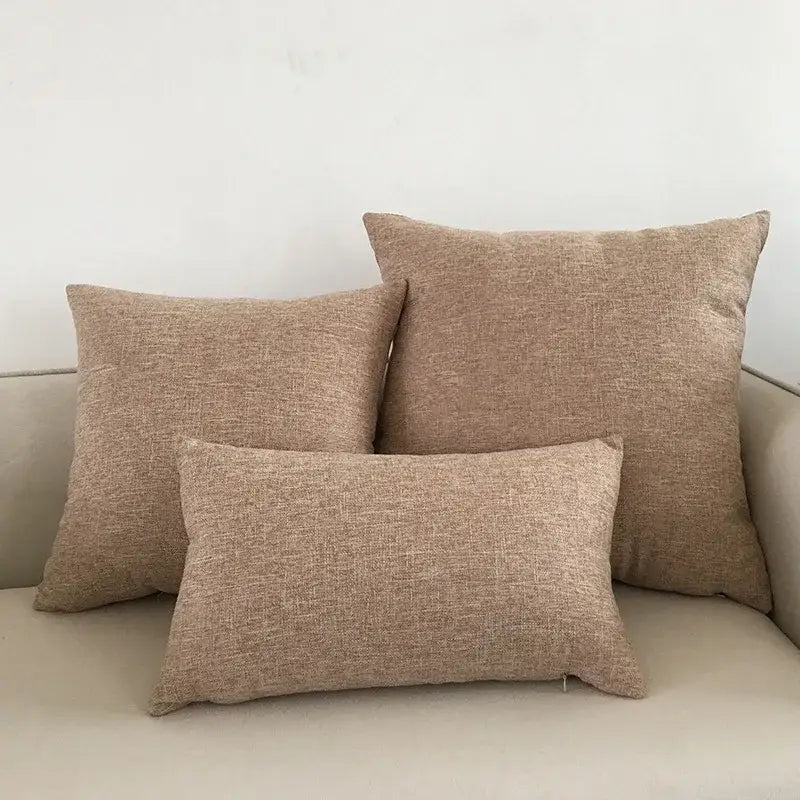 Three beige textured linen cushion covers arranged on a light decorbites ivory sofa for living room decorbites ivory sofa cushion