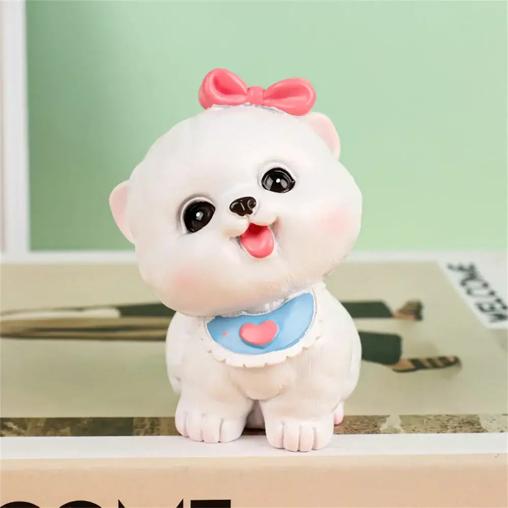 A cute white plush puppy dog figurine miniature with pink bow and blue bib in decorbites dog figurine miniatures set