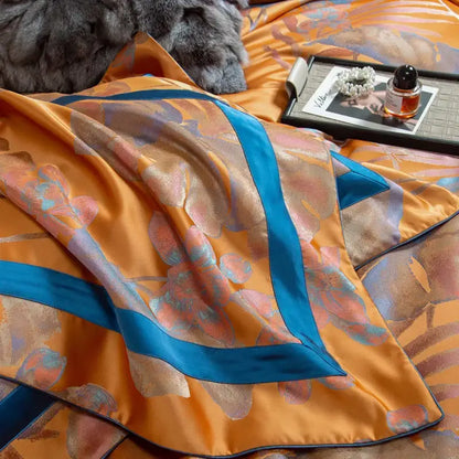 Orchid golden orange and teal egyptian cotton silk bedding set with orchid-patterned satin bedspread and bold teal border stripes