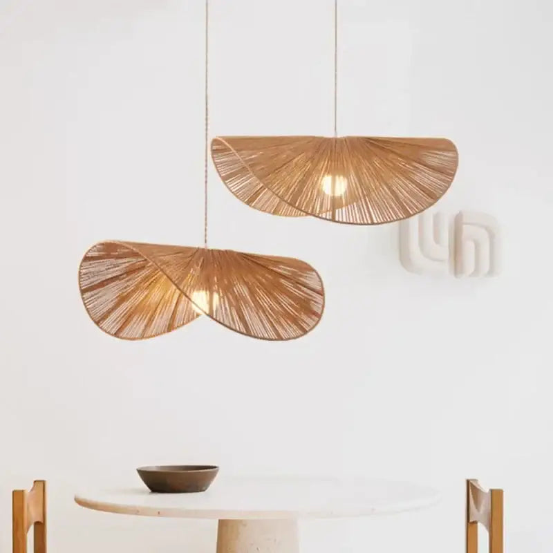 Two hanging pendant lights with warm amber tones made of decorbites handmade rattan led for dining room decor