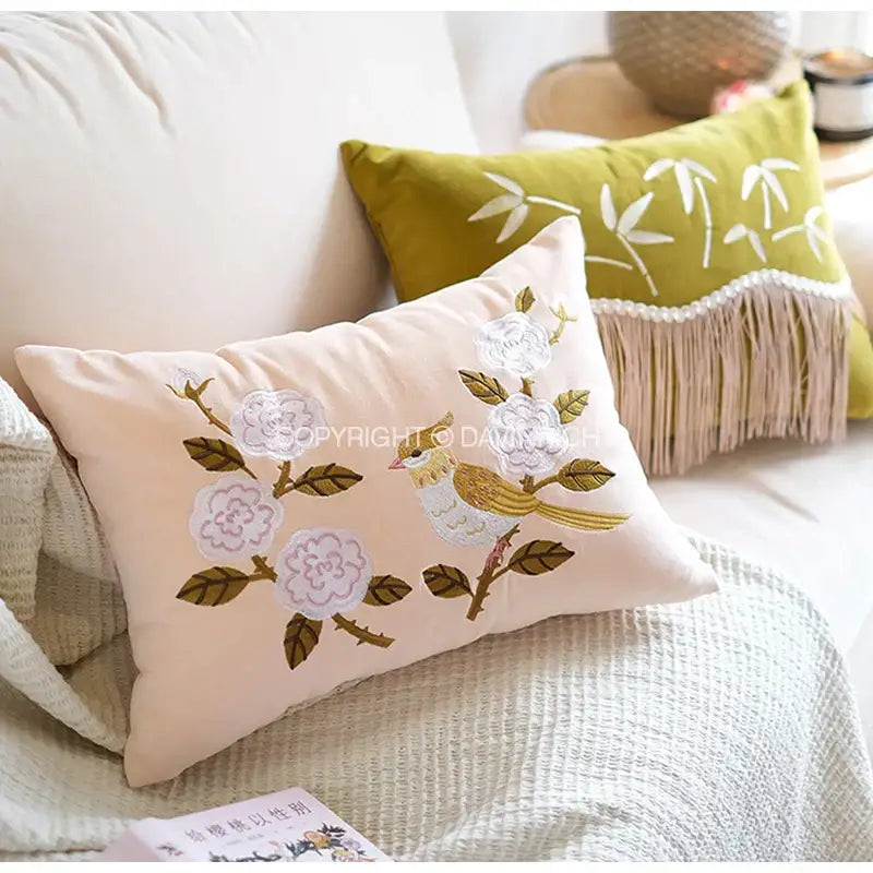 Beige rectangular pillow cover with decorbites bamboo embroidered white flowers green leaves and yellow bird design