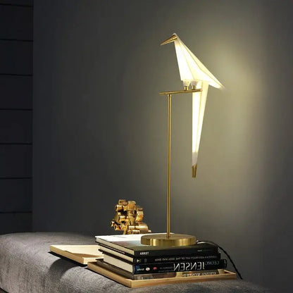 Gold-toned origami bird led floor lamp with sleek minimalist design providing warm ambient lighting for living room decorbites bird led