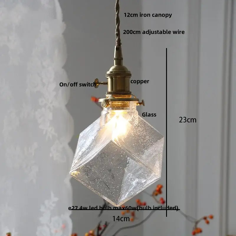 A warm-glowing amber copper led pendant light with faceted glass and brass fixture for café and dining room