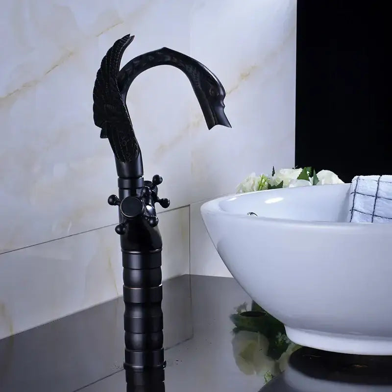 Ornate black bronze swan basin faucet with dual cross handles featuring detailed feathered wings and elegant curved spout