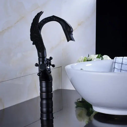Ornate black bronze swan basin faucet with dual cross handles featuring detailed feathered wings and elegant curved spout