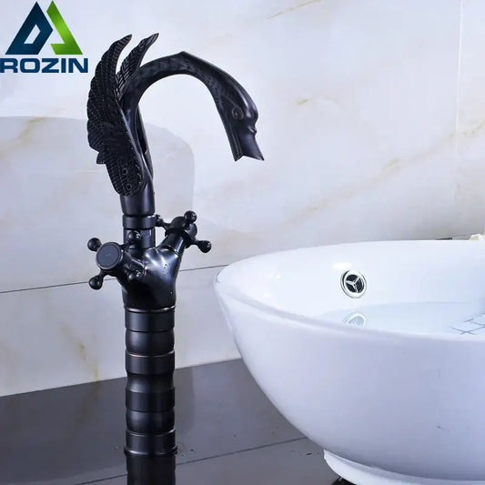 Ornate black bronze swan basin faucet with dual cross handles and matte finish featuring feathered decorbites design
