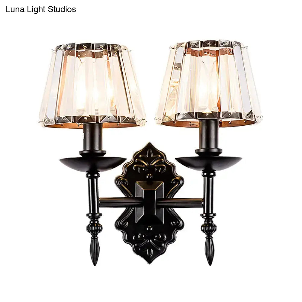 Ornate black finish wall light with crystal prisms and two crystal-encrusted lampshades for bedroom sconce lighting
