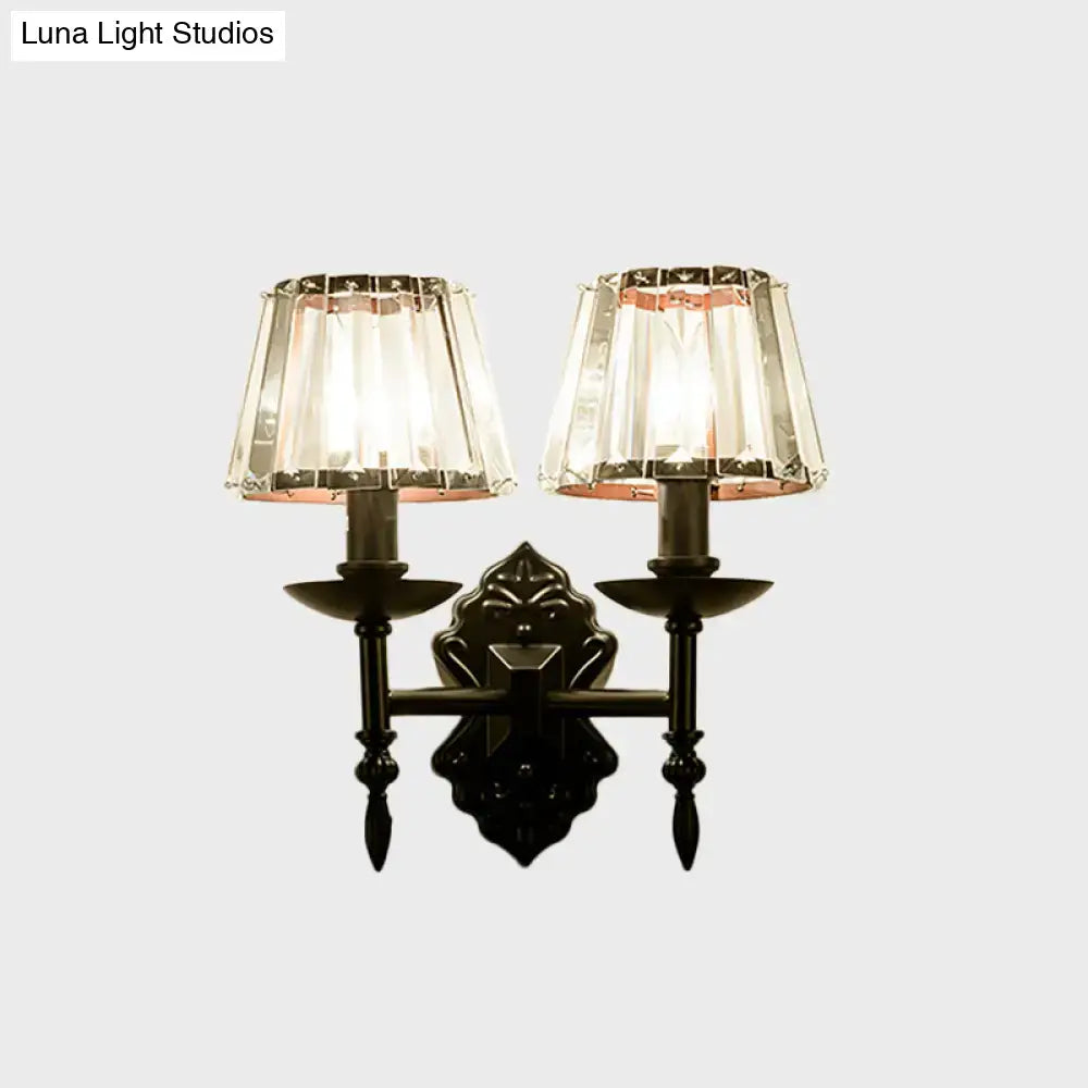 Ornate black finish wall light with crystal prisms and two lampshades for elegant bedroom sconce lighting